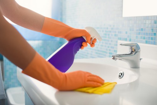 Carpet cleaner working safely with protective measures in place